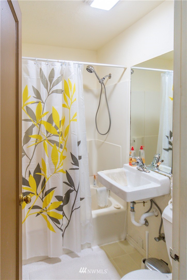 717 Franklin Street Port Townsend, WA 98368 - Photo 22 of 25 a bathroom with a sink mirror and a shower