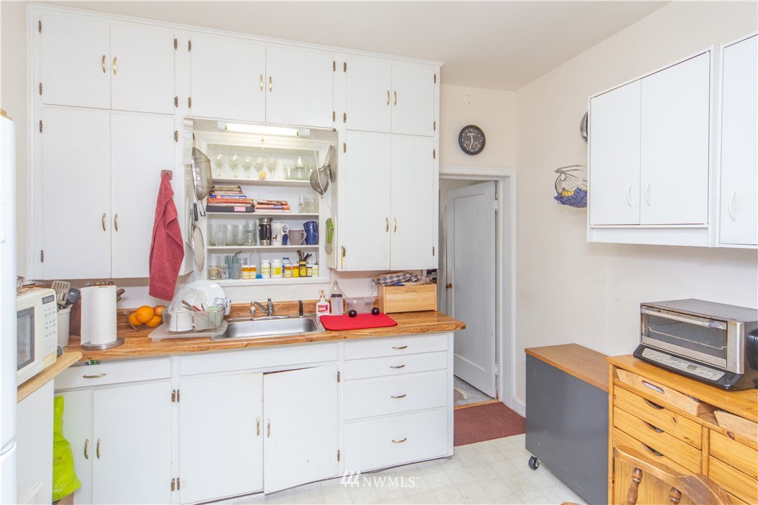 717 Franklin Street Port Townsend, WA 98368 - Photo 7 of 25 a kitchen with cabinets appliances and wooden floor