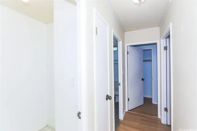 a view of a hallway with wooden floor