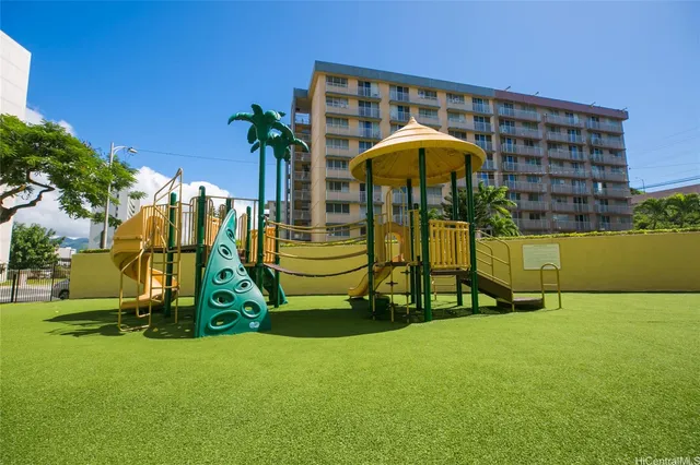 a view of a swimming pool with lawn chairs and plants