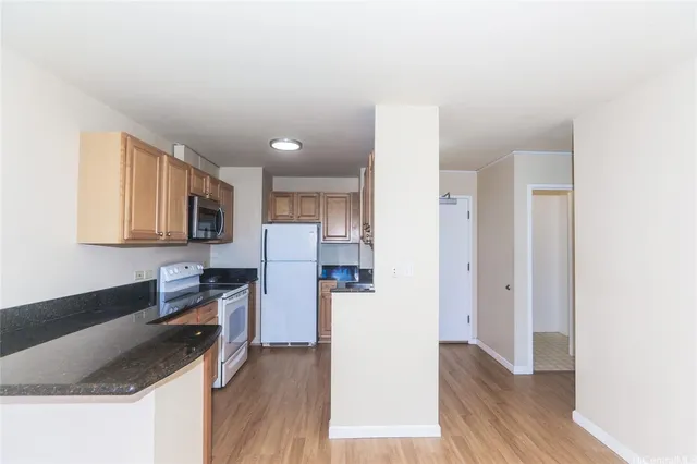 a kitchen with stainless steel appliances granite countertop a refrigerator sink and stove