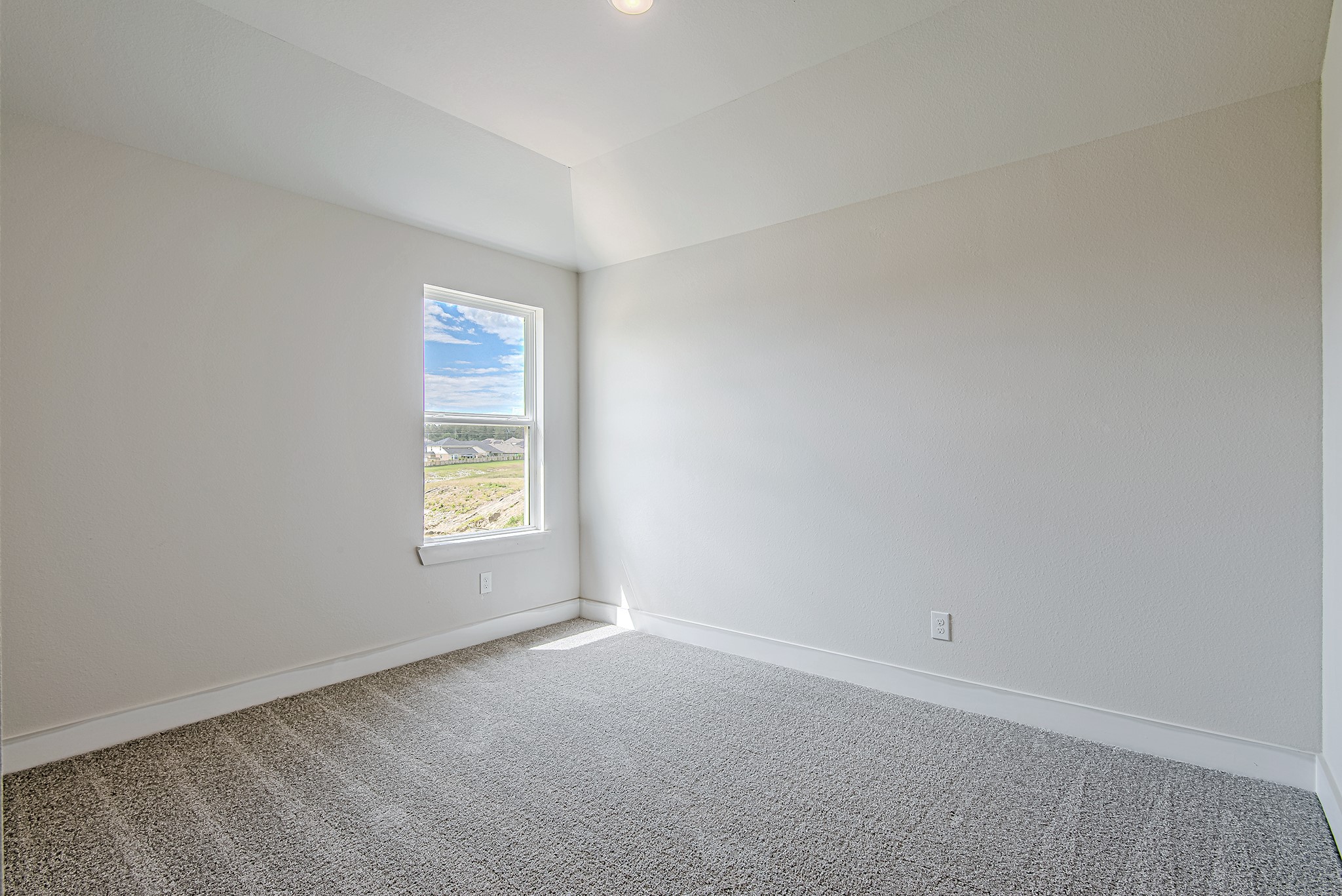 141 Peninsula Point Drive Montgomery, TX 77356 - Photo 36 of 47 Bright and airy secondary bedroom with soft neutral tones, plush carpet, and large windows offering peaceful neighborhood views and abundant natural light.