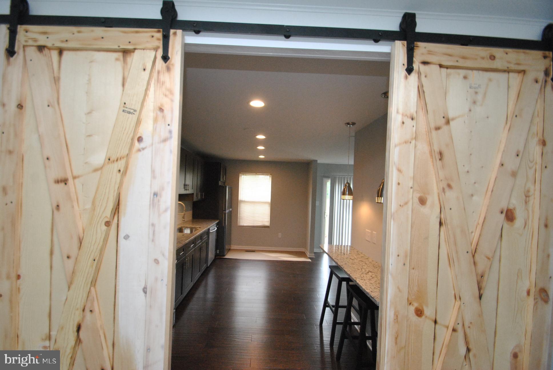 25 Open Gate Court Baltimore, MD 21236 - Photo 6 of 29 BARN SLIDER DOORS TO KITCHEN AREA