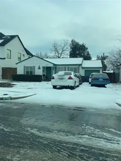 a yellow house with trees in front of it