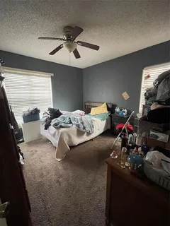 a bedroom with bed and a chandelier
