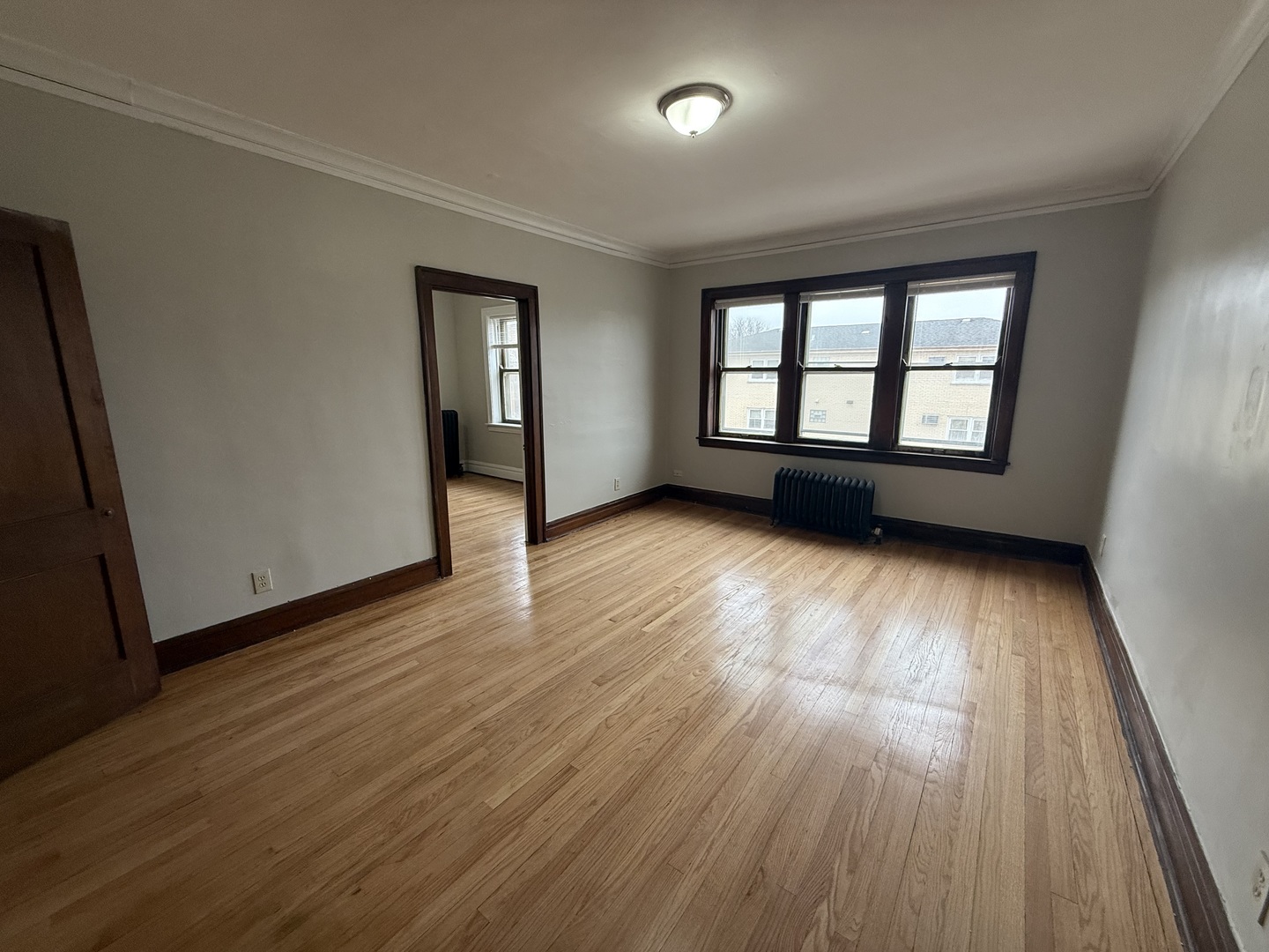 6829 21st Street, Unit 2E Berwyn, IL 60402 - Photo 2 of 15 an empty room with wooden floor and windows