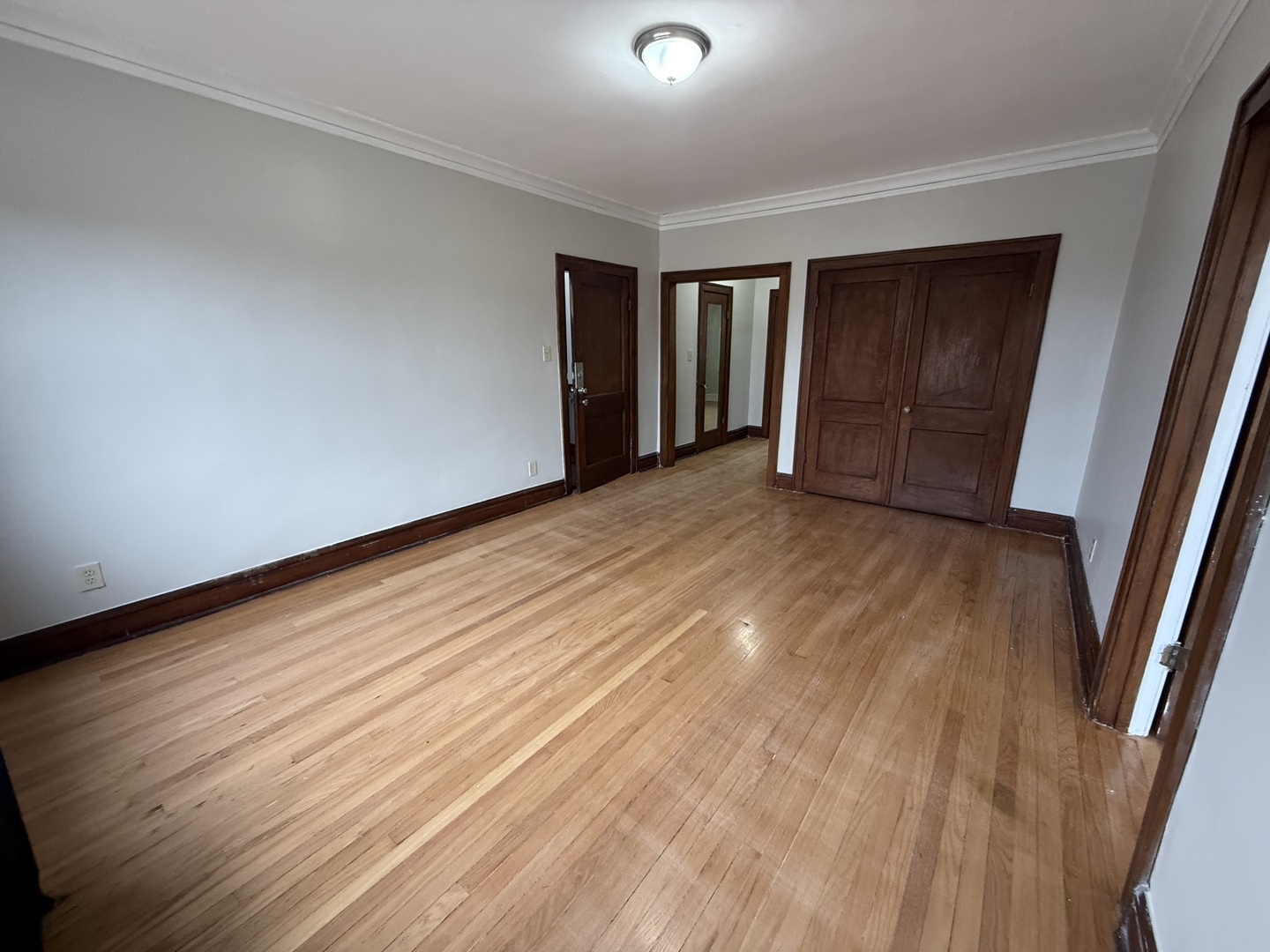6829 21st Street, Unit 2E Berwyn, IL 60402 - Photo 3 of 15 a view of an empty room with wooden floor and a window