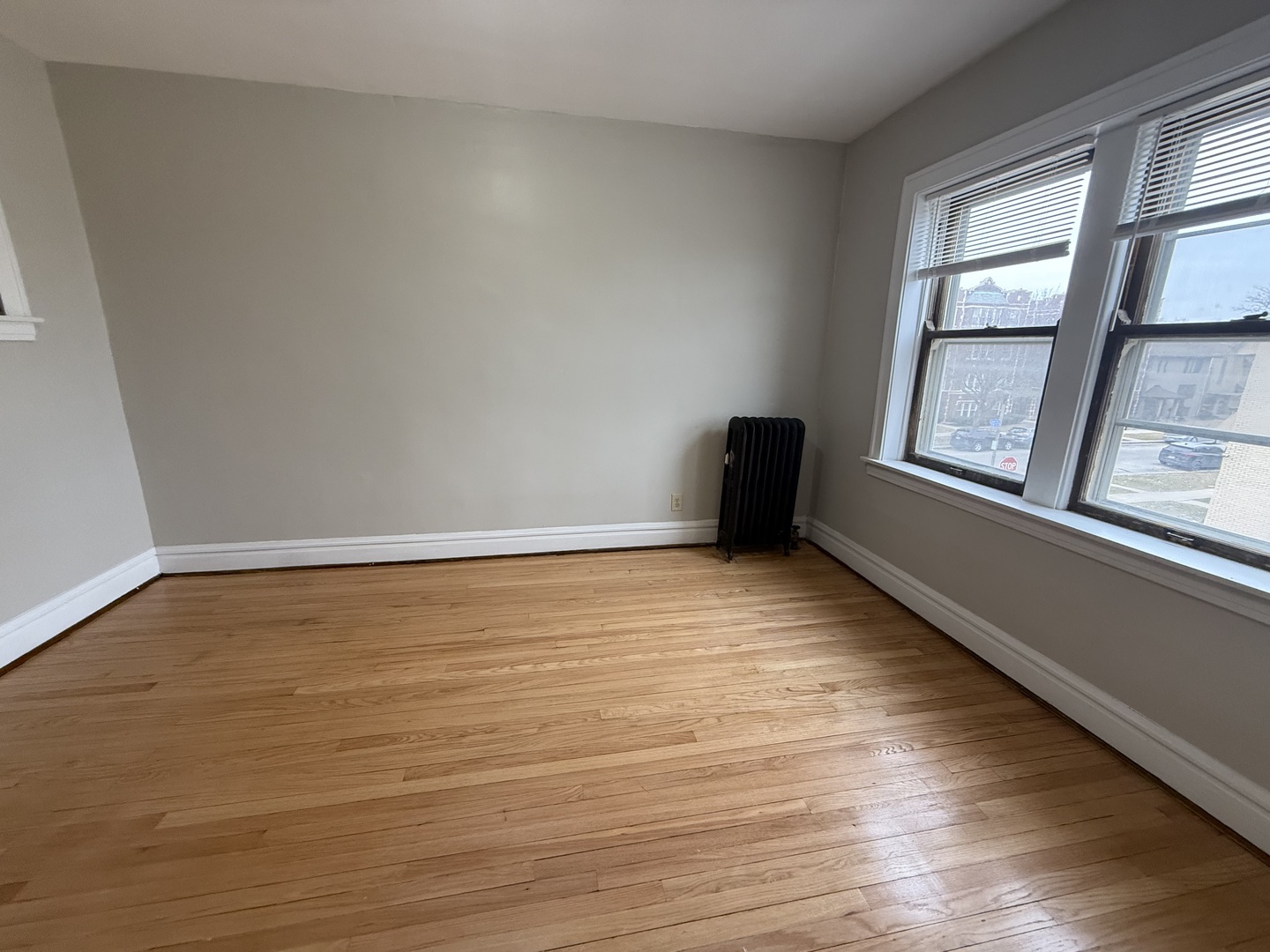6829 21st Street, Unit 2E Berwyn, IL 60402 - Photo 6 of 15 a view of an empty room with wooden floor and a window