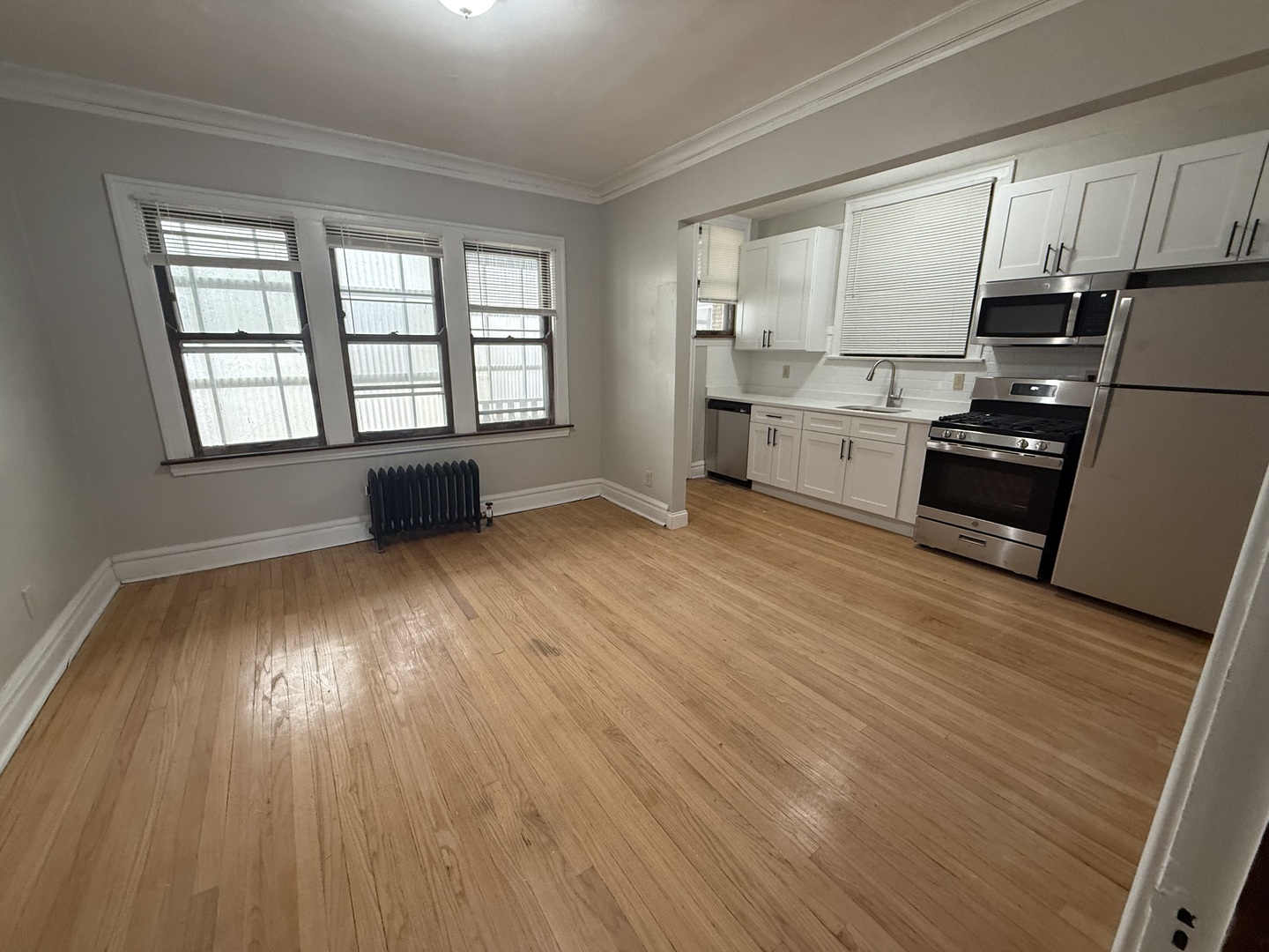 6829 21st Street, Unit 2E Berwyn, IL 60402 - Photo 7 of 15 a kitchen with stainless steel appliances a white cabinets and wooden floors
