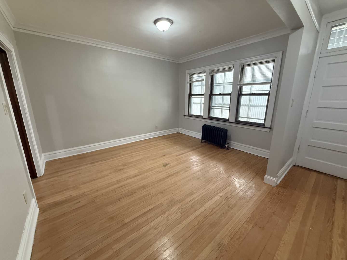 6829 21st Street, Unit 2E Berwyn, IL 60402 - Photo 8 of 15 an empty room with wooden floor and windows