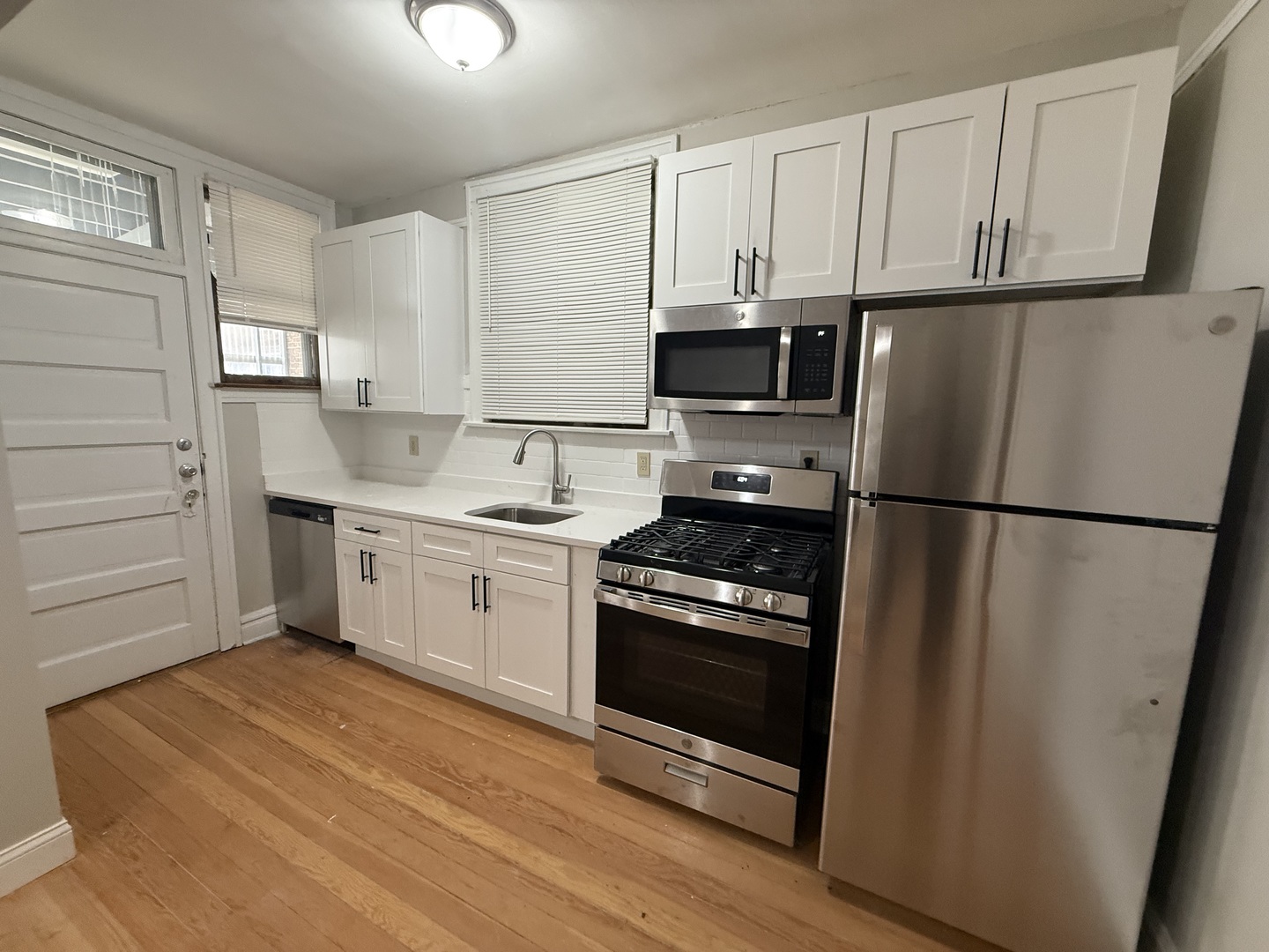 6829 21st Street, Unit 2E Berwyn, IL 60402 - Photo 9 of 15 a kitchen with a refrigerator stove and white cabinets