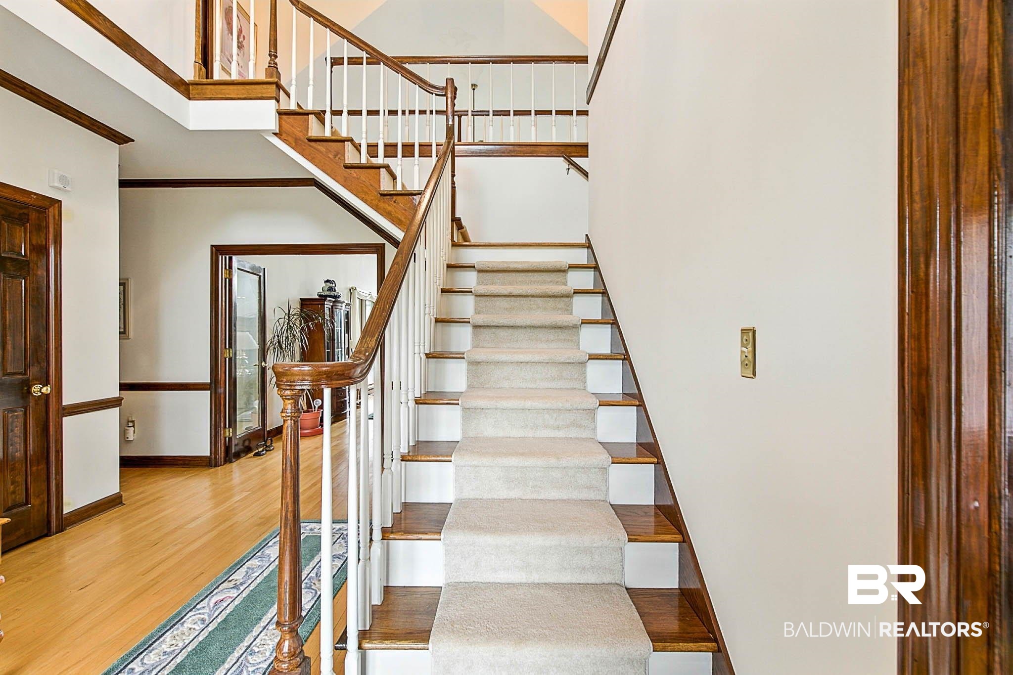 17270 Davis Road Summerdale, AL 36580 - Photo 17 of 97 Stairway with wood finished floors and a towering ceiling