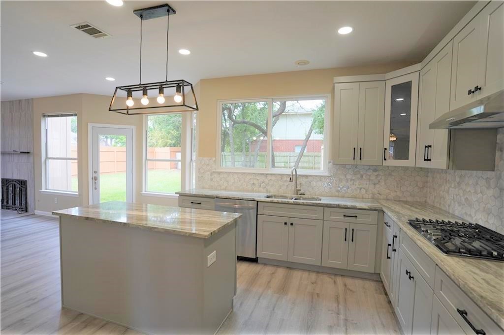 a large kitchen with lots of counter space and a sink