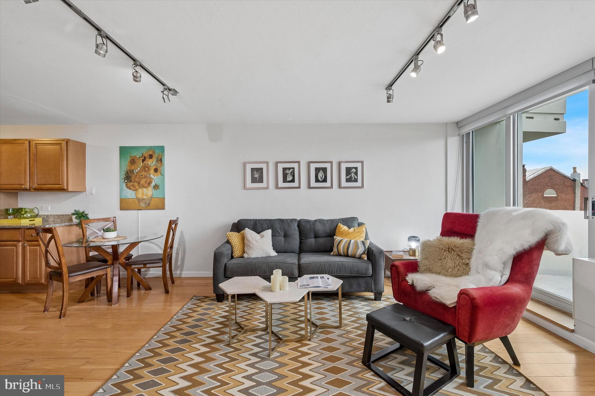 604 South Washington Square, Unit 309 Philadelphia, PA 19106 - Photo 6 of 28 a living room with furniture a rug and a dining table