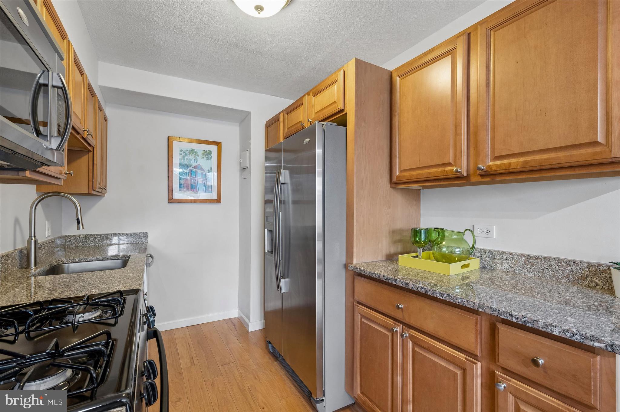 604 South Washington Square, Unit 309 Philadelphia, PA 19106 - Photo 8 of 28 a kitchen with stainless steel appliances granite countertop a sink stove and cabinets