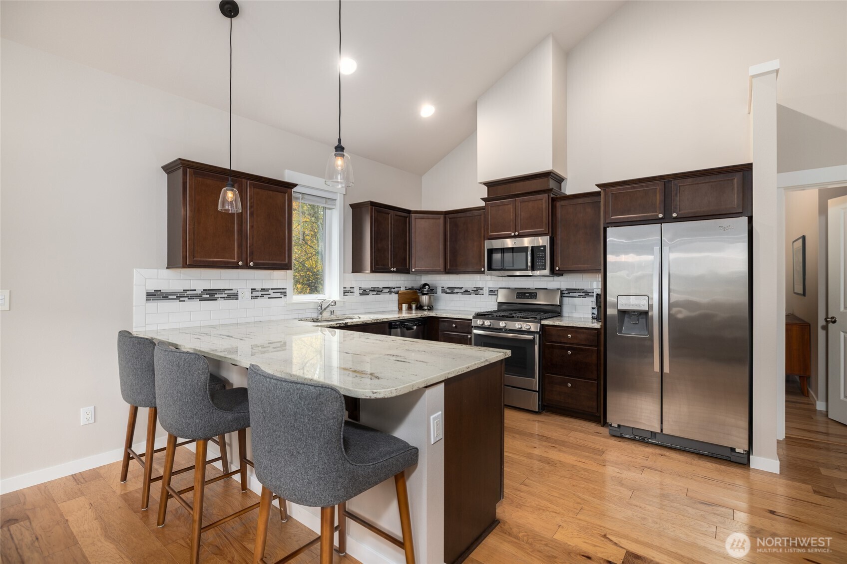 1107 Harmony Lane Mount Vernon, WA 98274 - Photo 13 of 27 a kitchen with stainless steel appliances kitchen island granite countertop a sink a stove a refrigerator and island