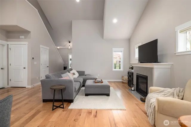 a living room with furniture a flat screen tv and a fireplace