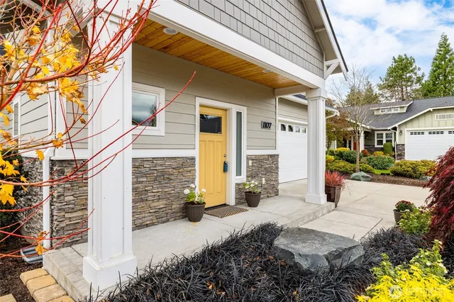 a front view of a house with a yard and outdoor seating