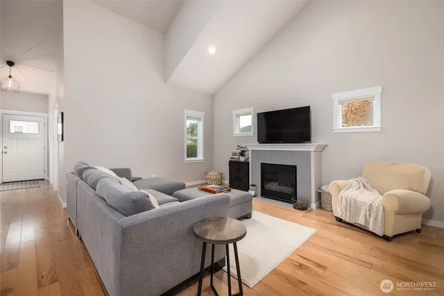 a living room with furniture a fireplace and a flat screen tv