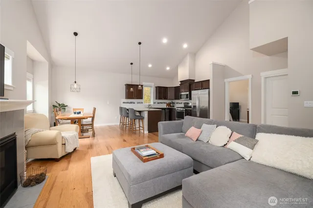 a living room with furniture white walls and kitchen view