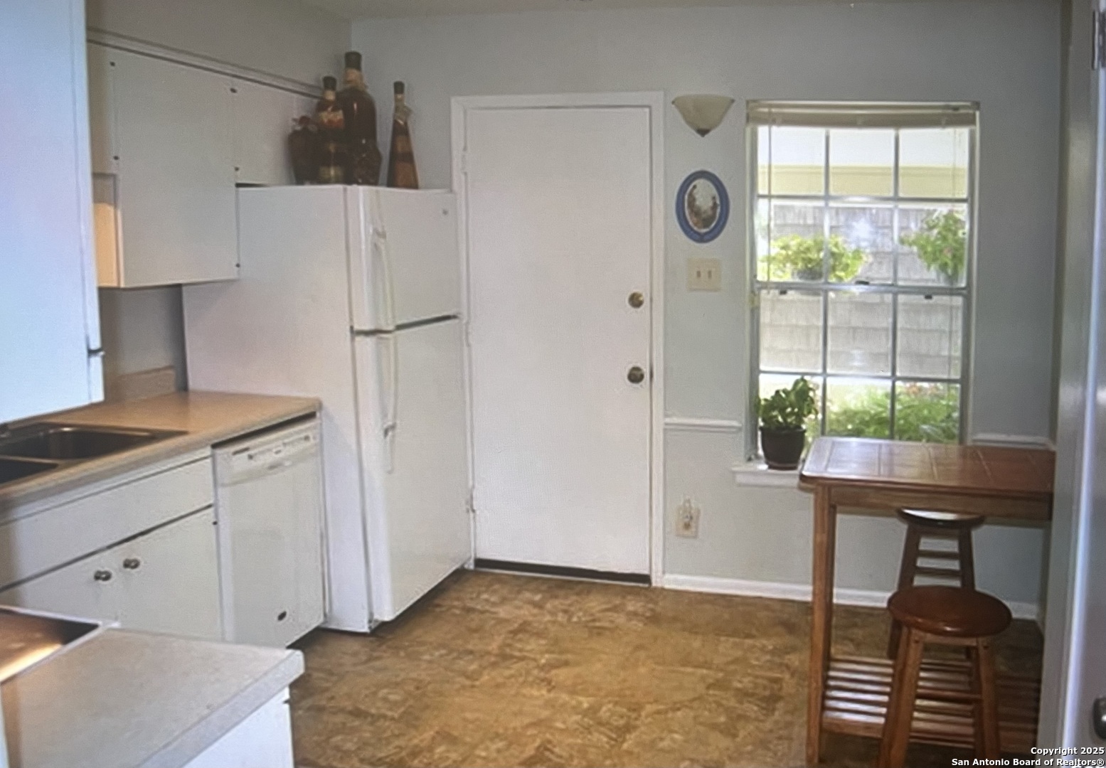 2300 Nacogdoches Road, Unit 263R San Antonio, TX 78209 - Photo 3 of 19 a kitchen with a refrigerator and a window