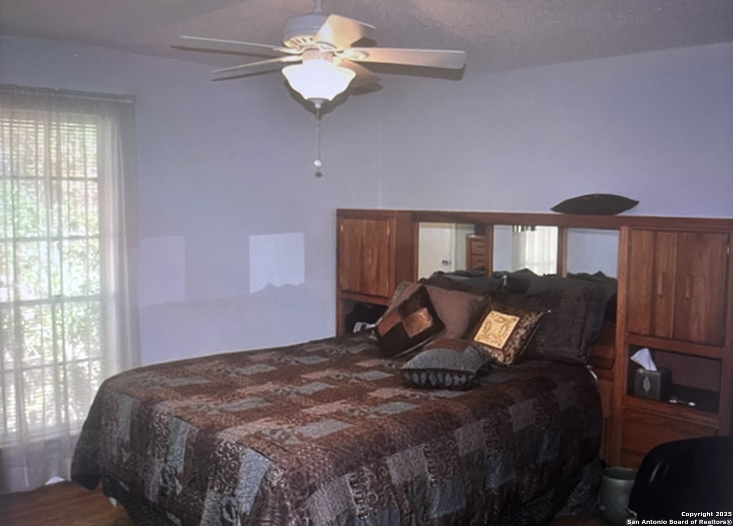 2300 Nacogdoches Road, Unit 263R San Antonio, TX 78209 - Photo 8 of 19 a bed sitting in a bedroom next to a window