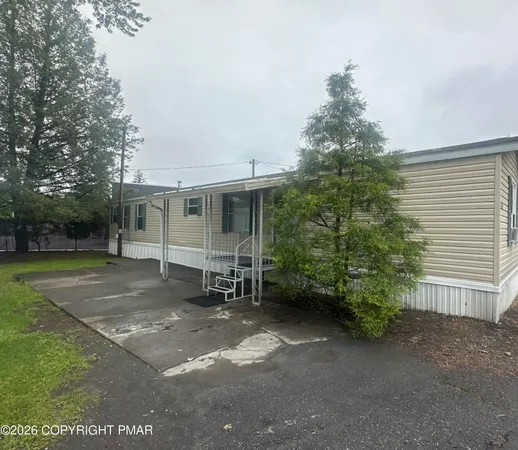 a view of a house with a yard and garage