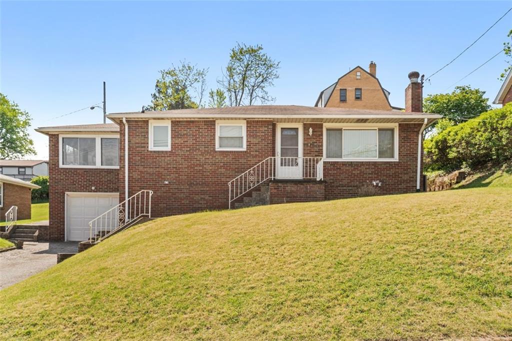 223 Washington Avenue Homestead, PA 15120 - Photo 1 of 31 a front view of a house with a yard