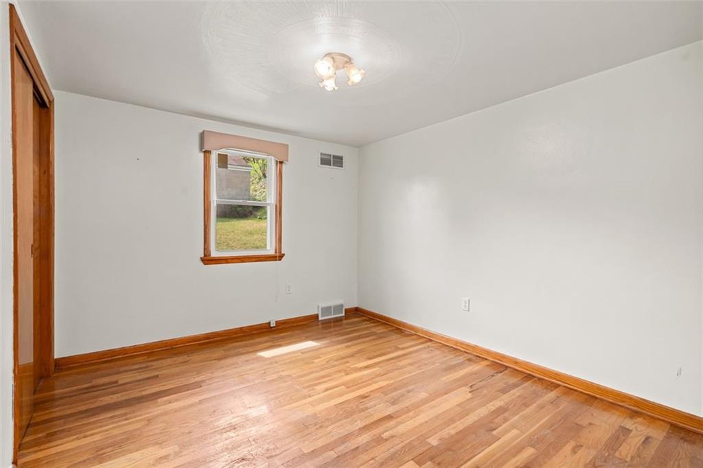 223 Washington Avenue Homestead, PA 15120 - Photo 13 of 31 an empty room with wooden floor and windows