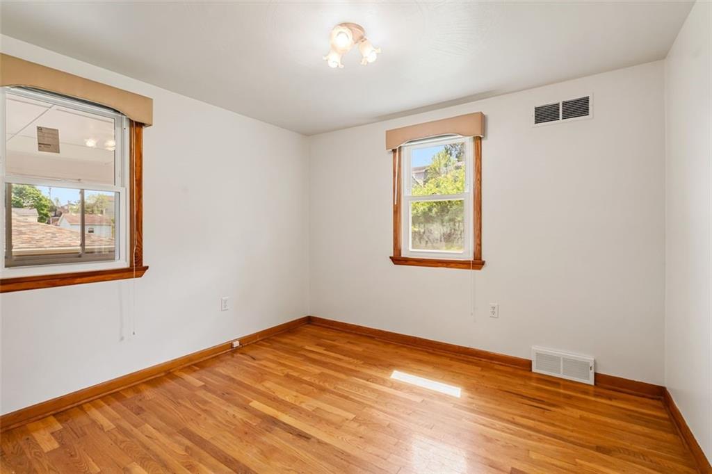 223 Washington Avenue Homestead, PA 15120 - Photo 14 of 31 a view of an empty room with window and wooden floor