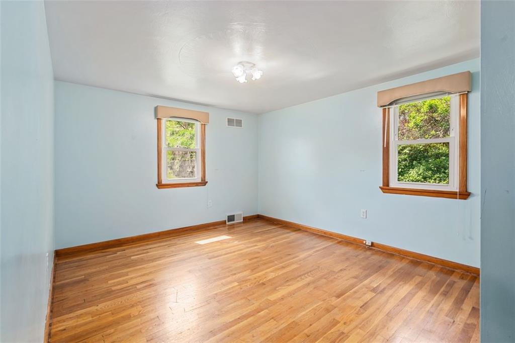 223 Washington Avenue Homestead, PA 15120 - Photo 16 of 31 wooden floor in an empty room with a window