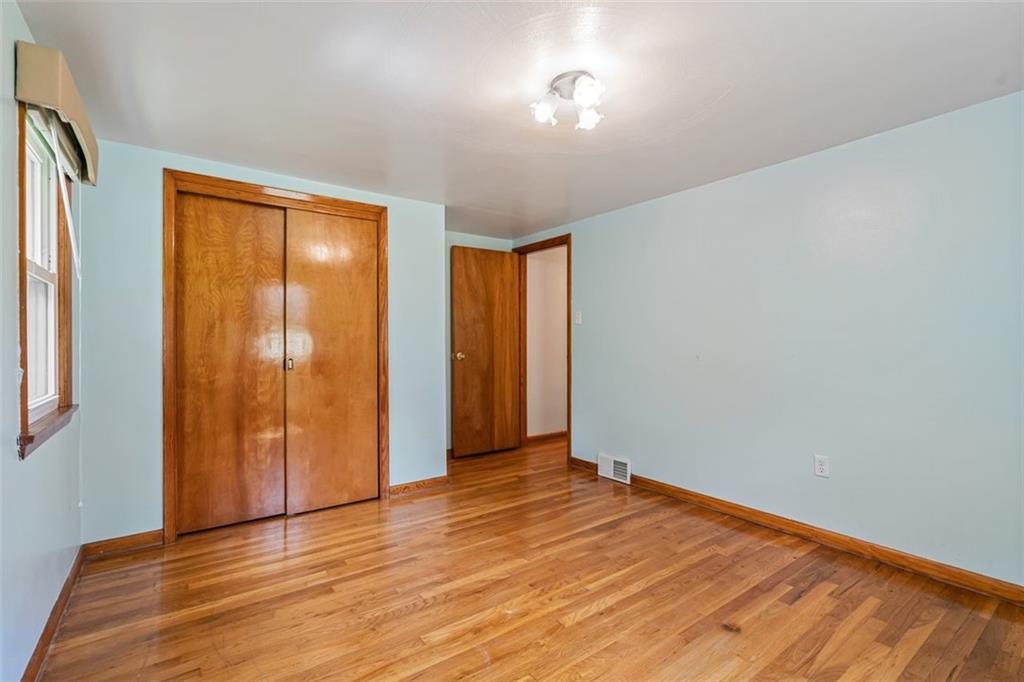 223 Washington Avenue Homestead, PA 15120 - Photo 17 of 31 a view of an empty room with wooden floor and a window