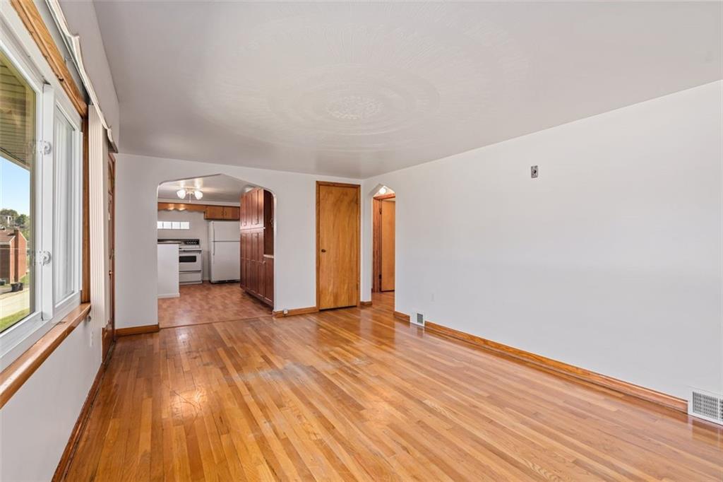 223 Washington Avenue Homestead, PA 15120 - Photo 5 of 31 a view of empty room with wooden floor