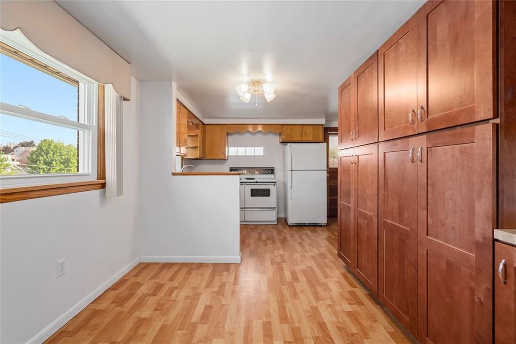223 Washington Avenue Homestead, PA 15120 - Photo 7 of 31 a view of a electric appliances in kitchen and wooden floor