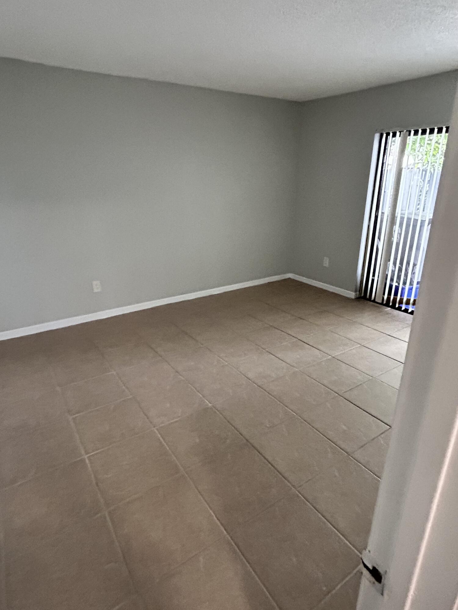 1158 Summit Trail Circle, Unit D West Palm Beach, FL 33415 - Photo 8 of 10 a view of an empty room and window
