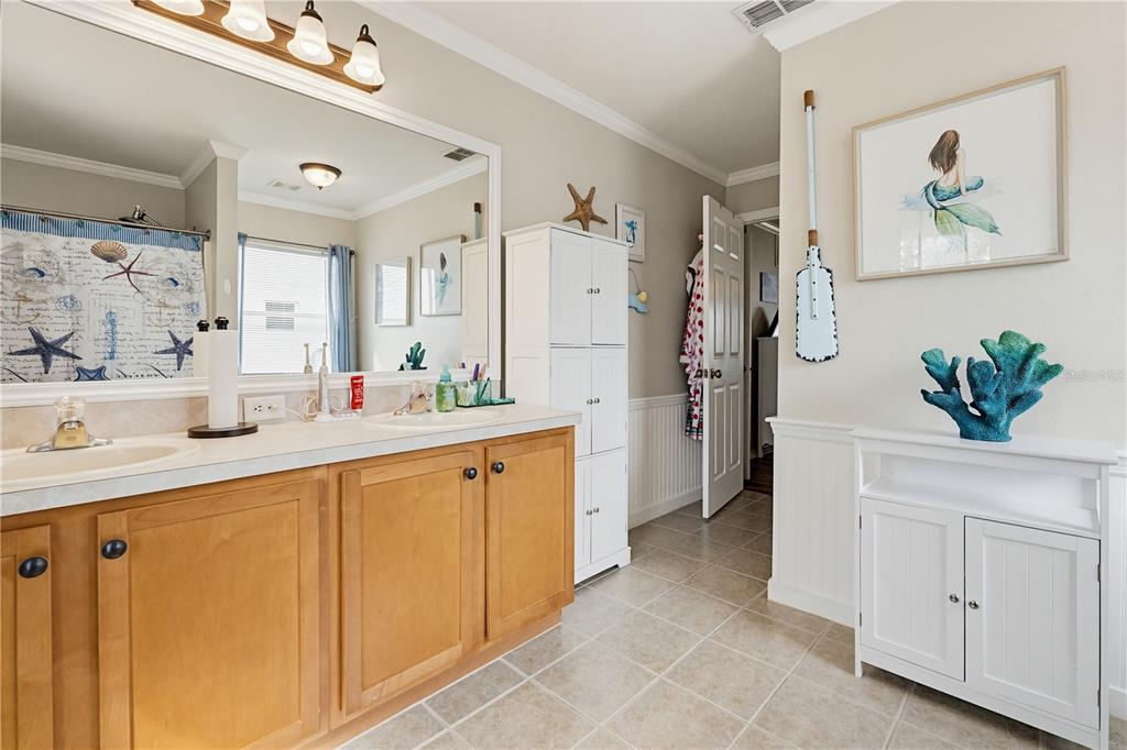 3497 Chadwick Avenue Spring Hill, FL 34609 - Photo 26 of 47 a spacious bathroom with a double vanity sink a mirror a shower and a bathtub