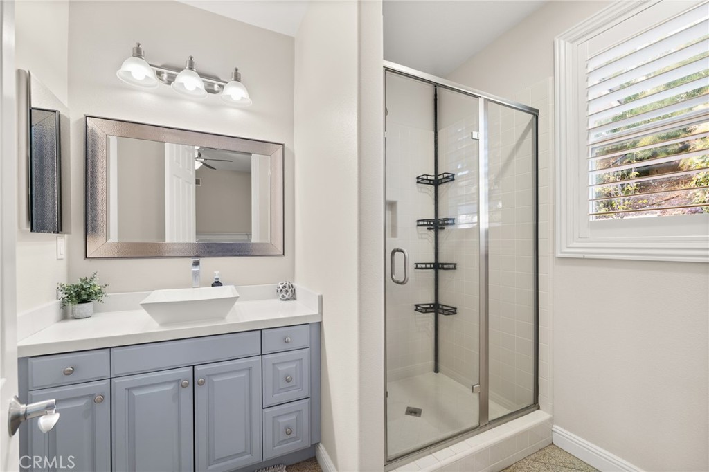 4947 Palomino Place Rancho Cucamonga, CA 91737 - Photo 21 of 53 a bathroom with a shower sink and mirror
