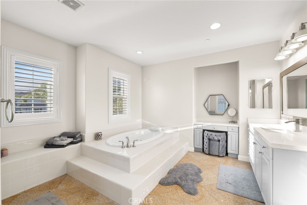 4947 Palomino Place Rancho Cucamonga, CA 91737 - Photo 28 of 53 a spacious bathroom with a tub a sink and a mirror
