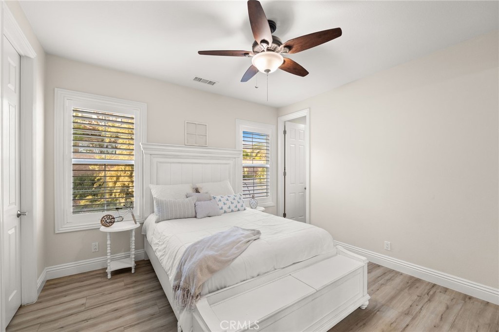 4947 Palomino Place Rancho Cucamonga, CA 91737 - Photo 32 of 53 a bedroom with a large bed chandelier and a window