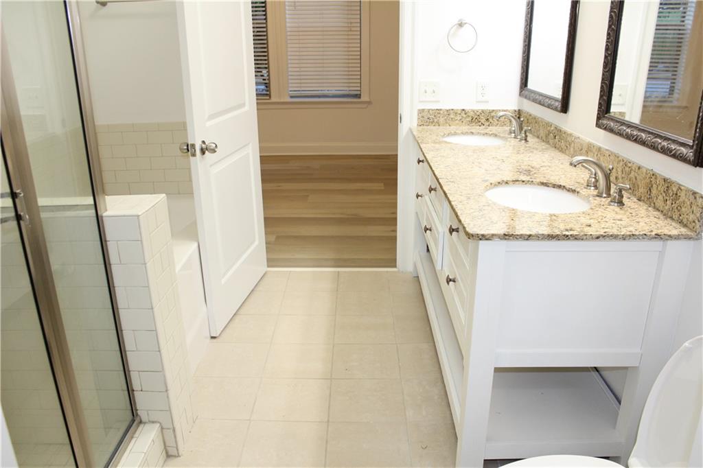 901 Abernathy Road Northeast, Unit 2110 Sandy Springs, GA 30328 - Photo 17 of 29 a bathroom with a granite countertop sink and a mirror