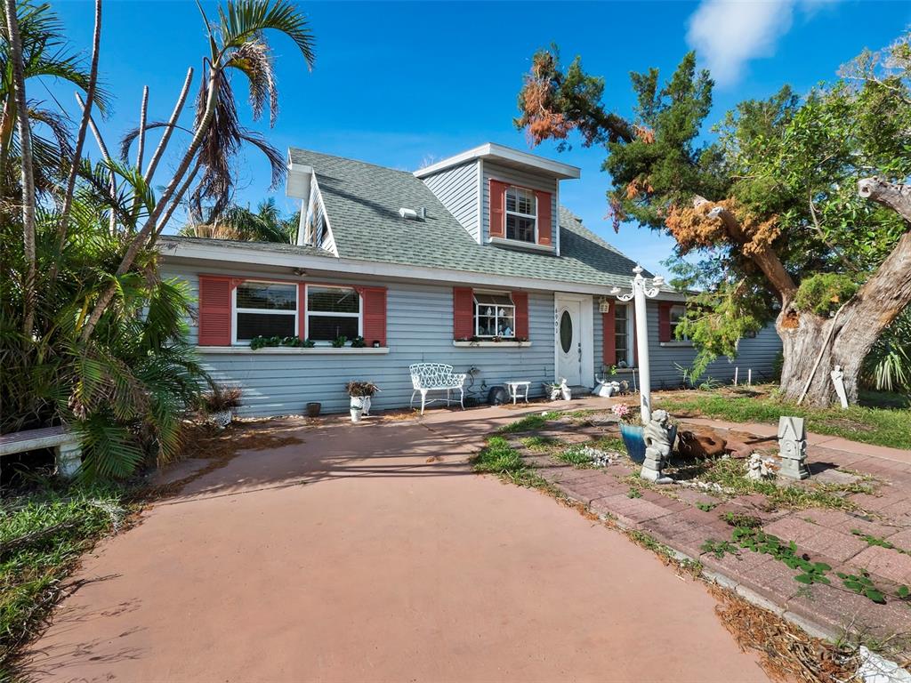 6901 Poinsetta Avenue Longboat Key, FL 34228 - Photo 8 of 30 a front view of a house with a yard