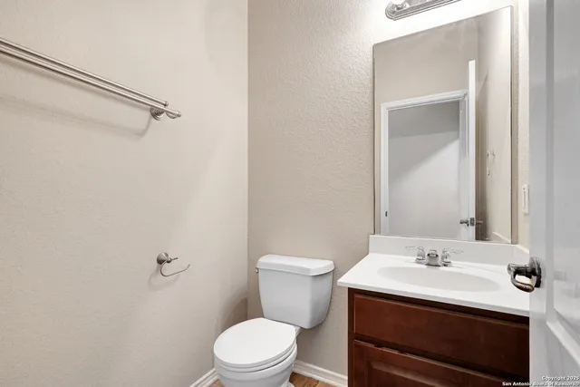 a bathroom with a sink a toilet and a mirror