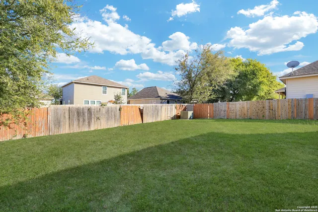 a view of yard with swimming pool and furniture