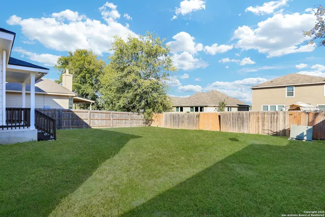 a view of yard with swimming pool and green space