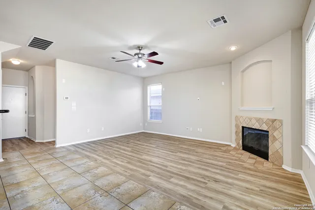 a view of an empty room with a fireplace