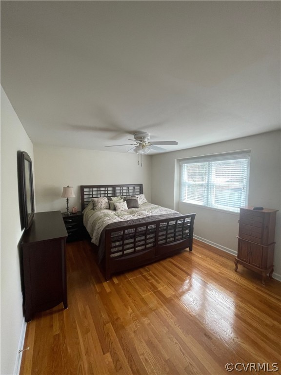 3809 Cresthill Road Chester, VA 23831 - Photo 14 of 44 a bedroom with a bed and wooden floor