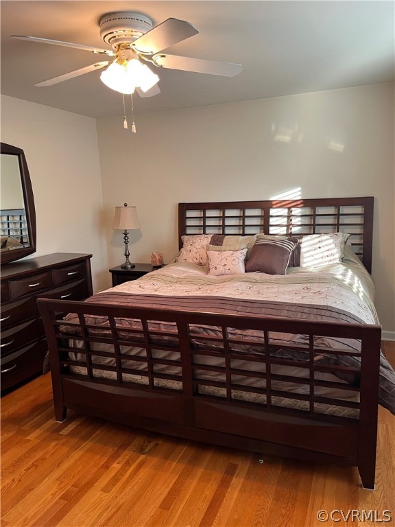 3809 Cresthill Road Chester, VA 23831 - Photo 15 of 44 a bedroom with a bed cabinets and wooden floor