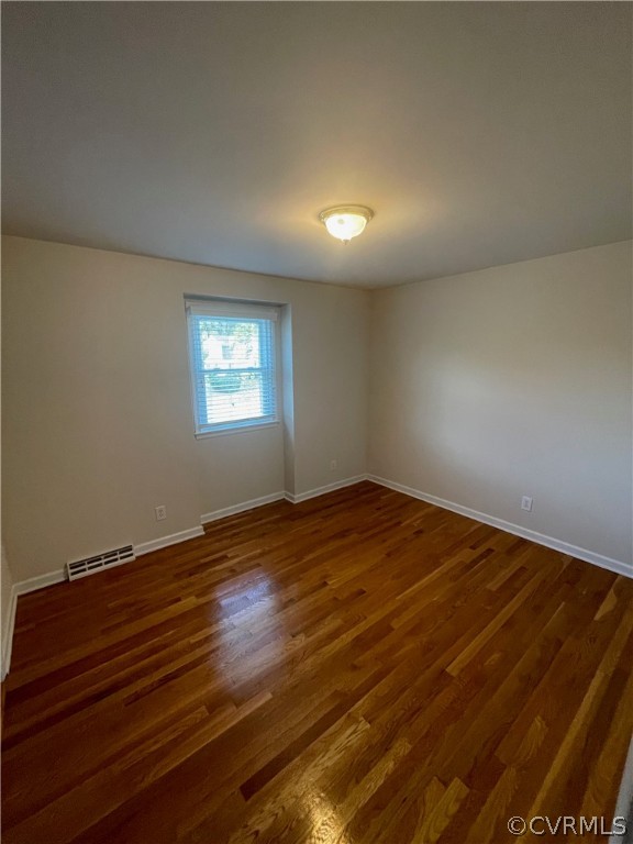 3809 Cresthill Road Chester, VA 23831 - Photo 21 of 44 an empty room with wooden floor and windows