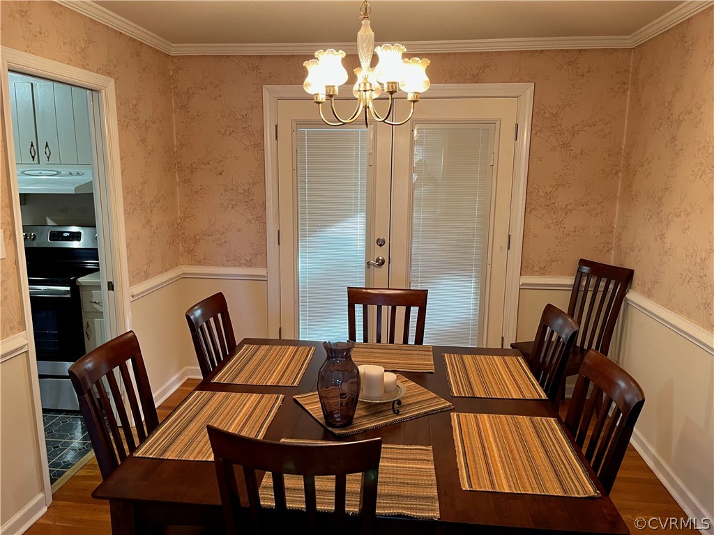 3809 Cresthill Road Chester, VA 23831 - Photo 6 of 44 a view of a dining room with furniture wooden floor and a chandelier