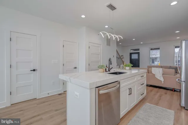 a bathroom with a granite countertop sink a large mirror and a vanity
